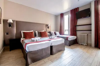 Un ou plusieurs lits dans un hébergement de l'établissement Hotel Migny Opéra Montmartre