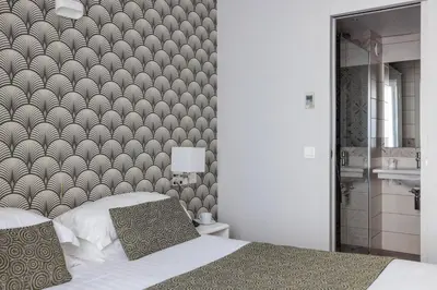 Un ou plusieurs lits dans un hébergement de l'établissement Hôtel Saint Martin Bastille