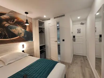 Un ou plusieurs lits dans un hébergement de l'établissement Atelier Montparnasse Hôtel