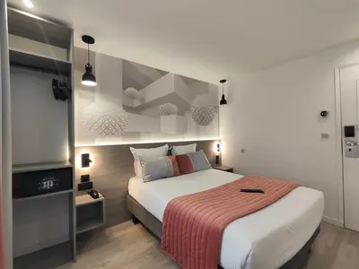 Un ou plusieurs lits dans un hébergement de l'établissement Atelier Montparnasse Hôtel