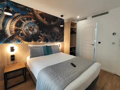 Un ou plusieurs lits dans un hébergement de l'établissement Atelier Montparnasse Hôtel