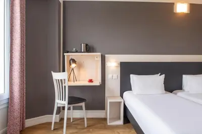 Un ou plusieurs lits dans un hébergement de l'établissement Hôtel Baldi by Magna Arbor