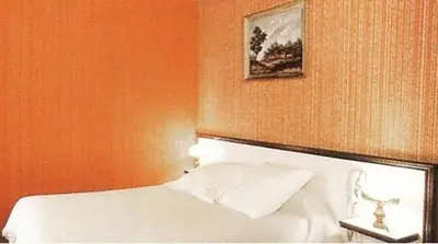 Un ou plusieurs lits dans un hébergement de l'établissement Avenir Hotel