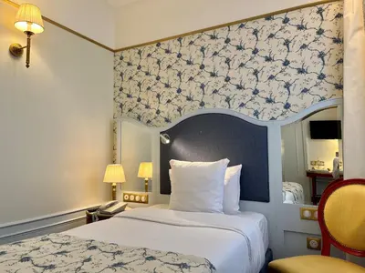 Un ou plusieurs lits dans un hébergement de l'établissement Hôtel Mayfair Paris