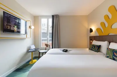 Un ou plusieurs lits dans un hébergement de l'établissement Ibis Styles Paris Jardin de la Villette - Rénové en 2025