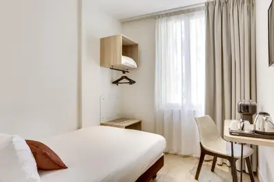 Un ou plusieurs lits dans un hébergement de l'établissement Hotel Courseine