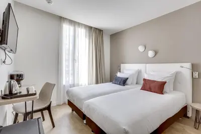 Un ou plusieurs lits dans un hébergement de l'établissement Hotel Courseine