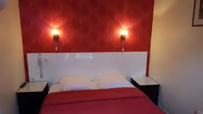 Un ou plusieurs lits dans un hébergement de l'établissement Hôtel Média