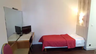 Un ou plusieurs lits dans un hébergement de l'établissement Hôtel Média