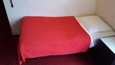 Un ou plusieurs lits dans un hébergement de l'établissement Hôtel Média