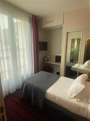Un ou plusieurs lits dans un hébergement de l'établissement Hotel Le Richemont