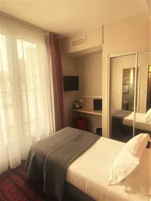 Un ou plusieurs lits dans un hébergement de l'établissement Hotel Le Richemont
