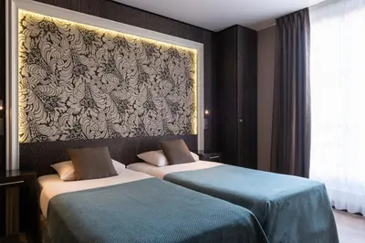 Un ou plusieurs lits dans un hébergement de l'établissement Central Hotel Paris
