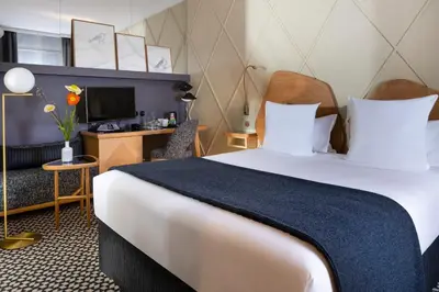 Un ou plusieurs lits dans un hébergement de l'établissement Millésime Hôtel
