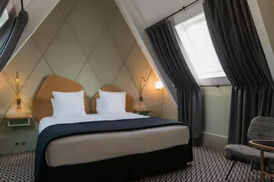 Un ou plusieurs lits dans un hébergement de l'établissement Millésime Hôtel