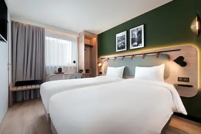 Un ou plusieurs lits dans un hébergement de l'établissement Campanile Prime Paris 19 - La Villette