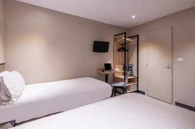 Un ou plusieurs lits dans un hébergement de l'établissement Hotel Lilas Blanc