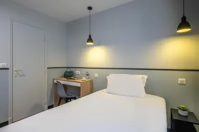 Un ou plusieurs lits dans un hébergement de l'établissement Hotel Lilas Blanc