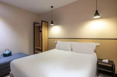 Un ou plusieurs lits dans un hébergement de l'établissement Hotel Lilas Blanc