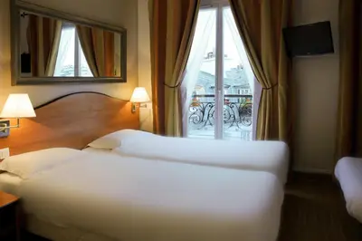 Un ou plusieurs lits dans un hébergement de l'établissement Hotel Eden Montmartre