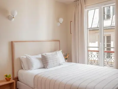 Un ou plusieurs lits dans un hébergement de l'établissement Hôtel BASSS