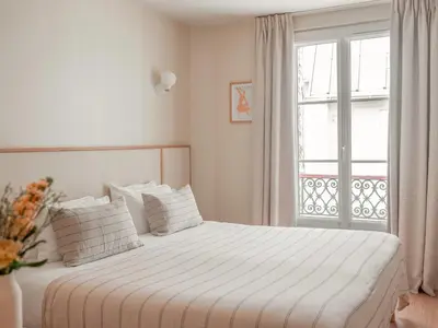Un ou plusieurs lits dans un hébergement de l'établissement Hôtel BASSS