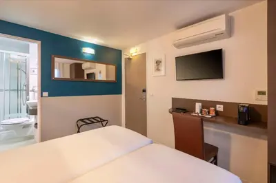 Un ou plusieurs lits dans un hébergement de l'établissement Hotel Apolonia Paris Mouffetard, Sure Hotel Collection by Best Western