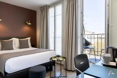 Un ou plusieurs lits dans un hébergement de l'établissement Hôtel Brady