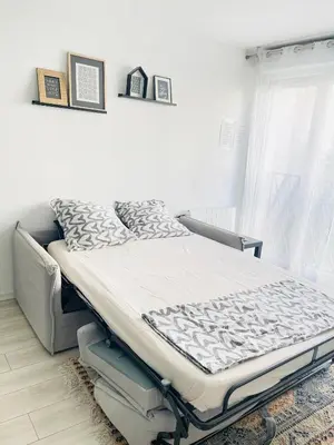 Un ou plusieurs lits dans un hébergement de l'établissement Cosy appart proche Paris