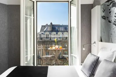 Un ou plusieurs lits dans un hébergement de l'établissement Hotel Marais Grands Boulevards
