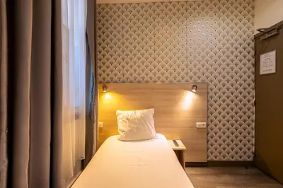 Un ou plusieurs lits dans un hébergement de l'établissement Hotel Aix Europe