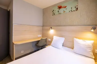 Un ou plusieurs lits dans un hébergement de l'établissement Hotel Aix Europe
