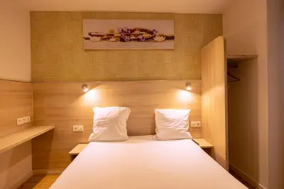 Un ou plusieurs lits dans un hébergement de l'établissement Hotel Aix Europe
