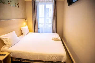 Un ou plusieurs lits dans un hébergement de l'établissement Hotel Aix Europe