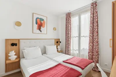 Un ou plusieurs lits dans un hébergement de l'établissement Hôtel Alexandrine Opera