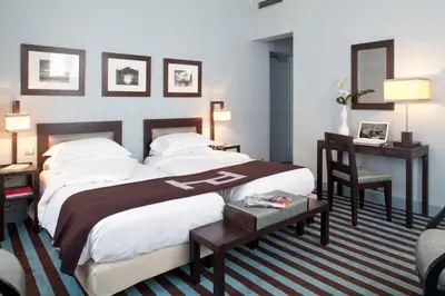 Un ou plusieurs lits dans un hébergement de l'établissement Hotel Duret Paris Champs Elysées