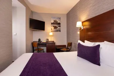 Un ou plusieurs lits dans un hébergement de l'établissement Hôtel L'Interlude