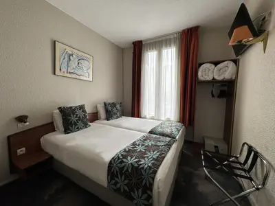 Un ou plusieurs lits dans un hébergement de l'établissement Timhotel Boulogne Rives de Seine