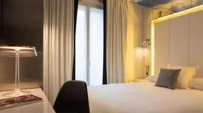Un ou plusieurs lits dans un hébergement de l'établissement Nouvel Hôtel Eiffel