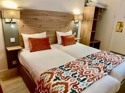 Un ou plusieurs lits dans un hébergement de l'établissement Hôtel Derby Eiffel