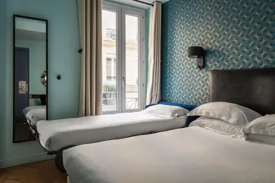 Un ou plusieurs lits dans un hébergement de l'établissement Hotel Elysée Etoile