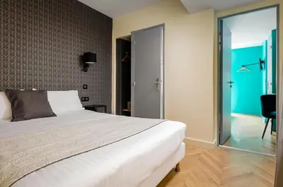 Un ou plusieurs lits dans un hébergement de l'établissement Hotel Elysée Etoile