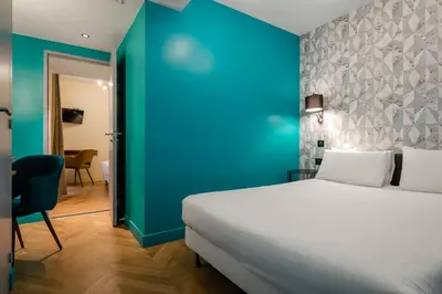 Un ou plusieurs lits dans un hébergement de l'établissement Hotel Elysée Etoile