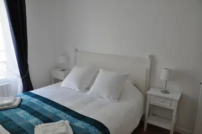 Un ou plusieurs lits dans un hébergement de l'établissement Résidence du Cygne - Swan Residence - Paris centre