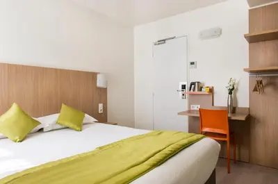 Un ou plusieurs lits dans un hébergement de l'établissement Hotel Bel Oranger Gare de Lyon