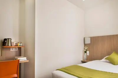 Un ou plusieurs lits dans un hébergement de l'établissement Hotel Bel Oranger Gare de Lyon