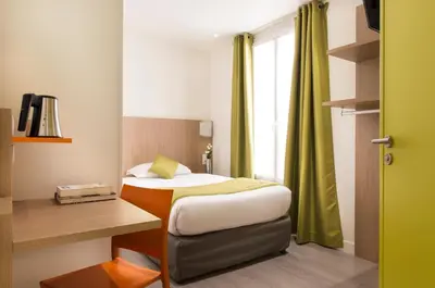 Un ou plusieurs lits dans un hébergement de l'établissement Hotel Bel Oranger Gare de Lyon
