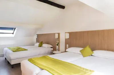 Un ou plusieurs lits dans un hébergement de l'établissement Hotel Bel Oranger Gare de Lyon