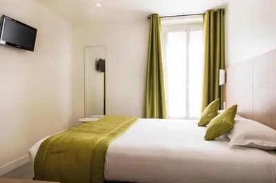 Un ou plusieurs lits dans un hébergement de l'établissement Hotel Bel Oranger Gare de Lyon