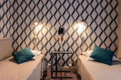Un ou plusieurs lits dans un hébergement de l'établissement Grand Hôtel De Paris